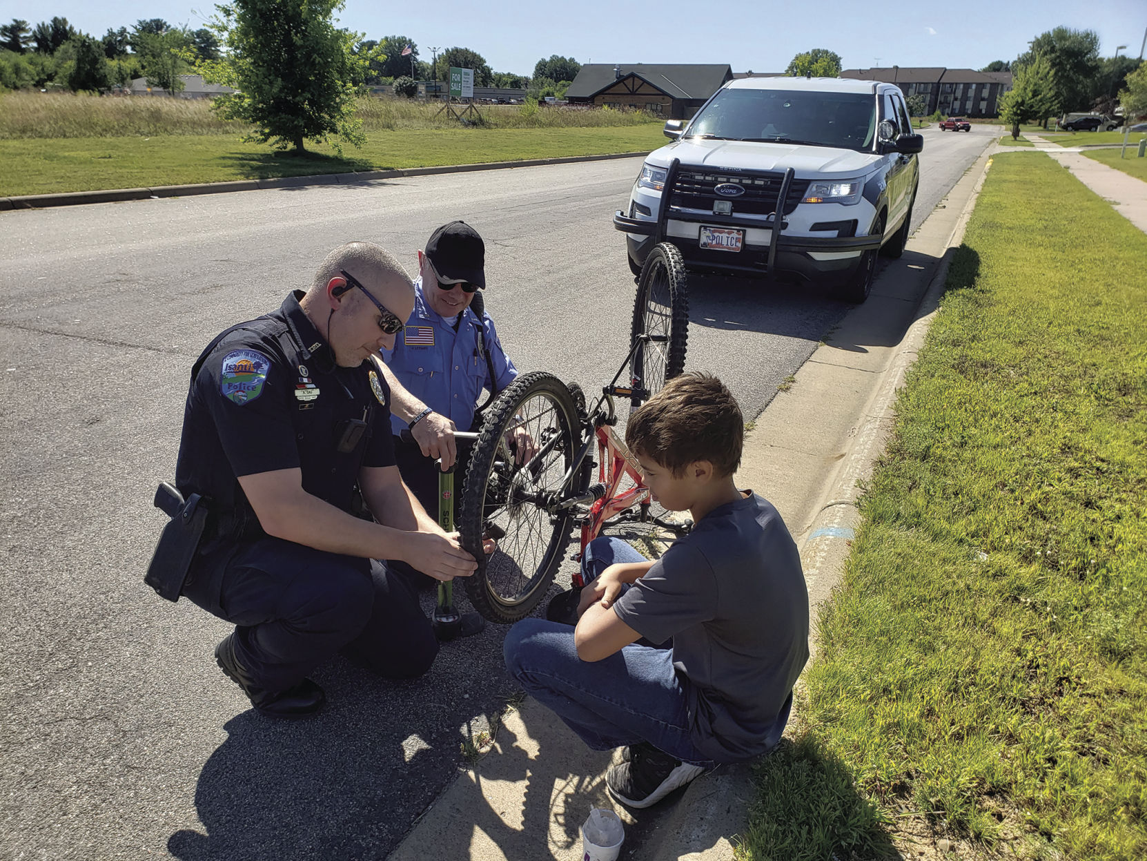 Officers assist youth with flat tire